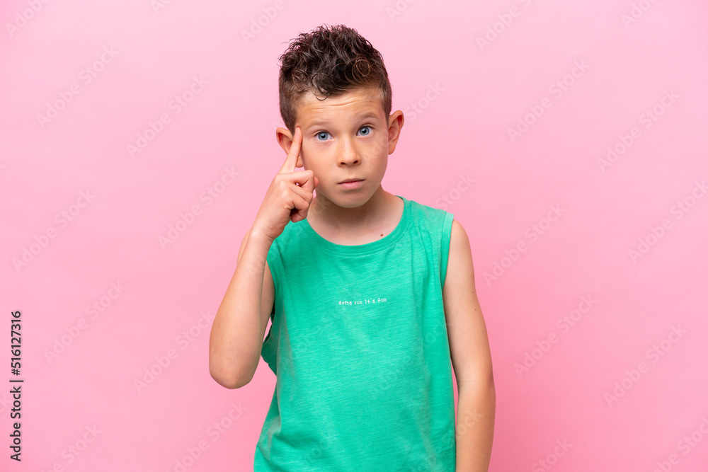 Little caucasian boy isolated on pink background thinking an idea Little caucasian boy isolated on pink background thinking an idea