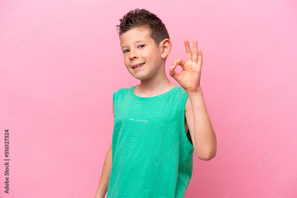 Little caucasian boy isolated on pink background showing ok sign with fingers Little caucasian boy isolated on pink background showing ok sign with fingers