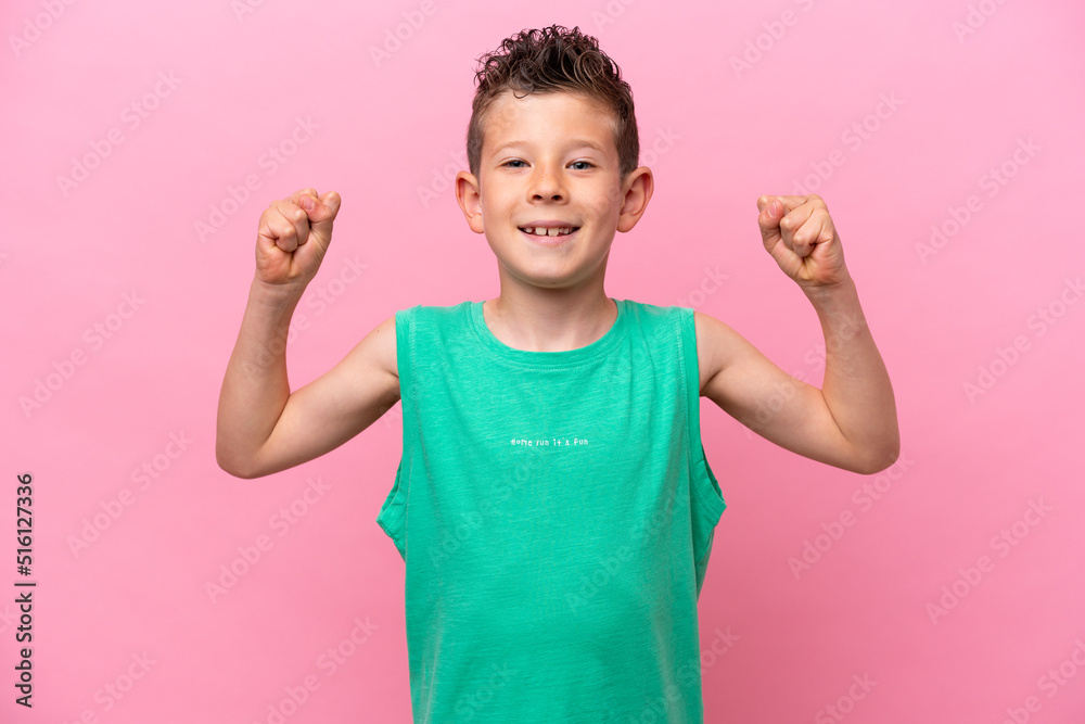 Little caucasian boy isolated on pink background doing strong gesture Little caucasian boy isolated on pink background doing strong gesture