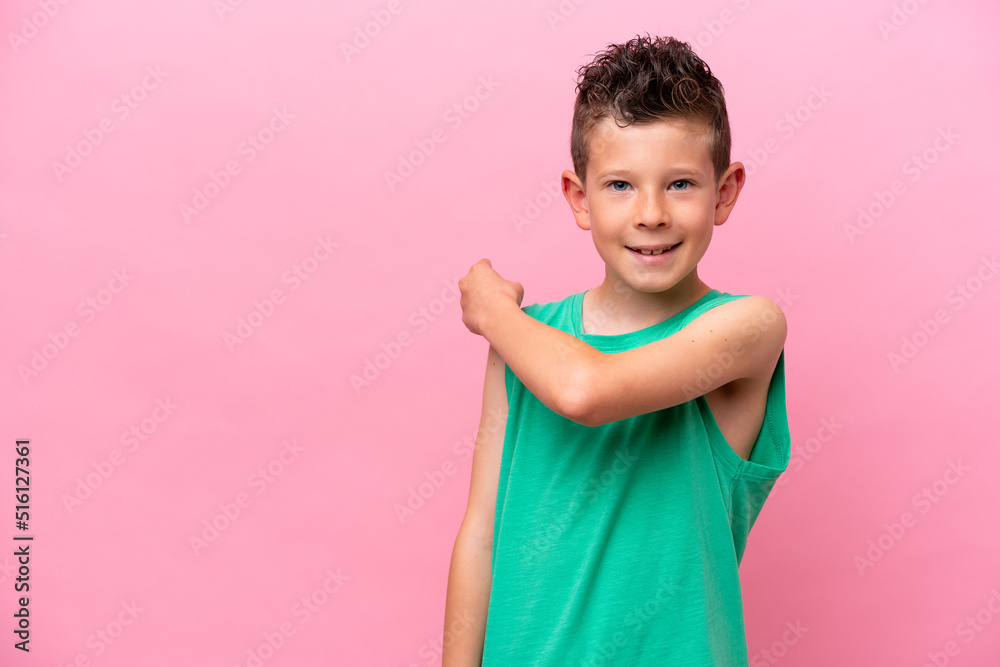 Little caucasian boy isolated on pink background pointing back Little caucasian boy isolated on pink background pointing back