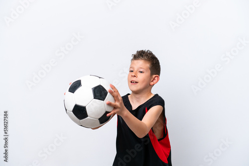 Boy playing football over isolated white wall © luismolinero