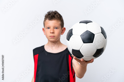 Boy playing football over isolated white wall