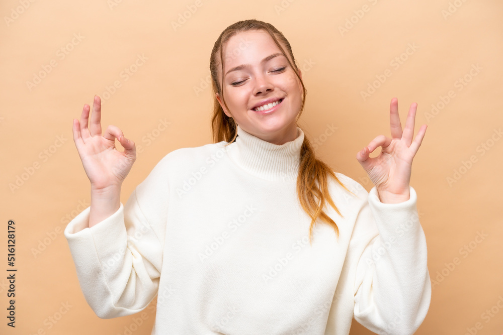 Young caucasian woman isolated on beige background in zen pose Young caucasian woman isolated on beige background in zen pose