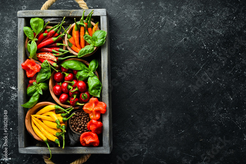 Spices in a wooden box  basil  pepper  oil  paprika  herbs. Food background. Top view.