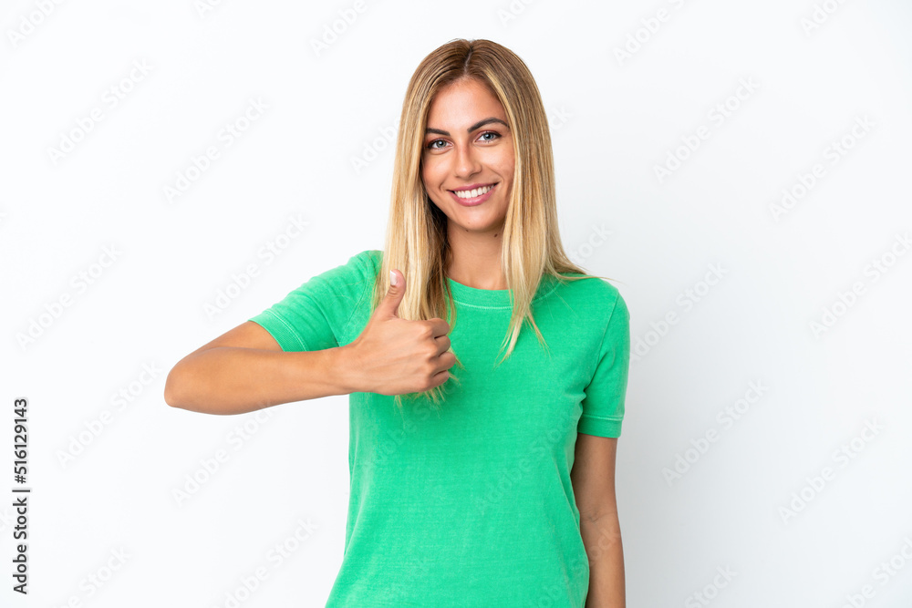 Blonde Uruguayan girl isolated on white background giving a thumbs up gesture