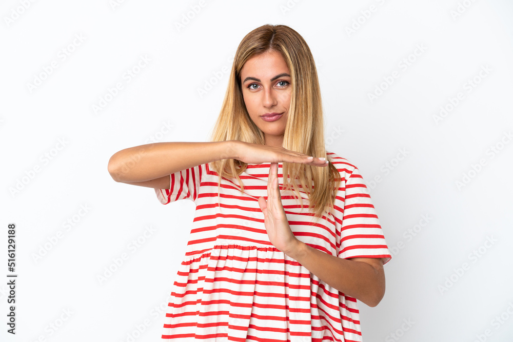 Blonde Uruguayan girl isolated on white background making time out gesture Blonde Uruguayan girl isolated on white background making time out gesture
