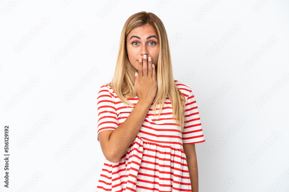 Blonde Uruguayan girl isolated on white background covering mouth with hand Blonde Uruguayan girl isolated on white background covering mouth with hand