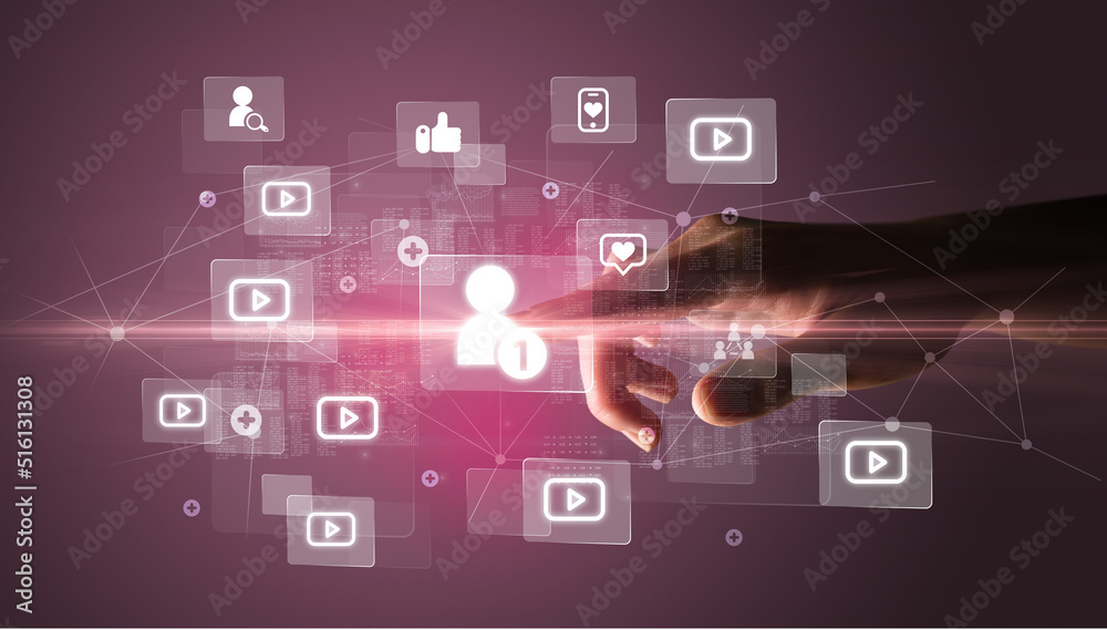 Hand pressing social media multimedia application screen with media icons on futuristic concept Hand pressing social media multimedia application screen with media icons on futuristic concept