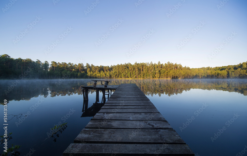 Wide view on a small lagoon in Mazury lakes area in Poland just before daybreak / after dawn. Wide angle Landscape scene.