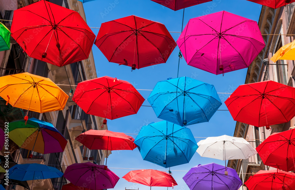 Obraz premium Colorful umbrellas background. Colorful umbrellas in the sky. Street decoration.