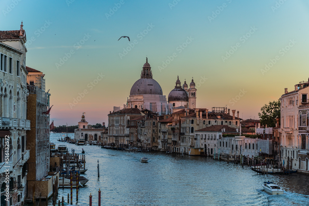 Incredible sunset view and traditional venetian architecture seen from the grand canal in Venice, Italy