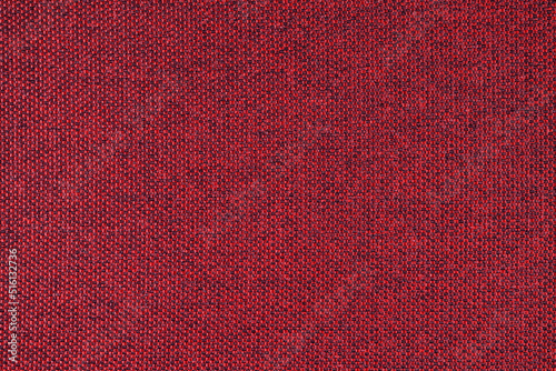 Close-up texture of natural red coarse weave fabric or cloth. Fabric texture of natural cotton or linen textile material. Blue canvas background. Decorative fabric for upholstery, furniture, walls