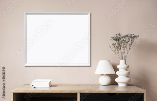 Empty horizontal frame mockup in modern minimalist interior with plant in trendy vase on beige wall background. Template for artwork, painting, photo or poster © kite_rin