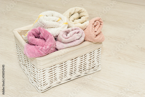 towels in a white wicker basket