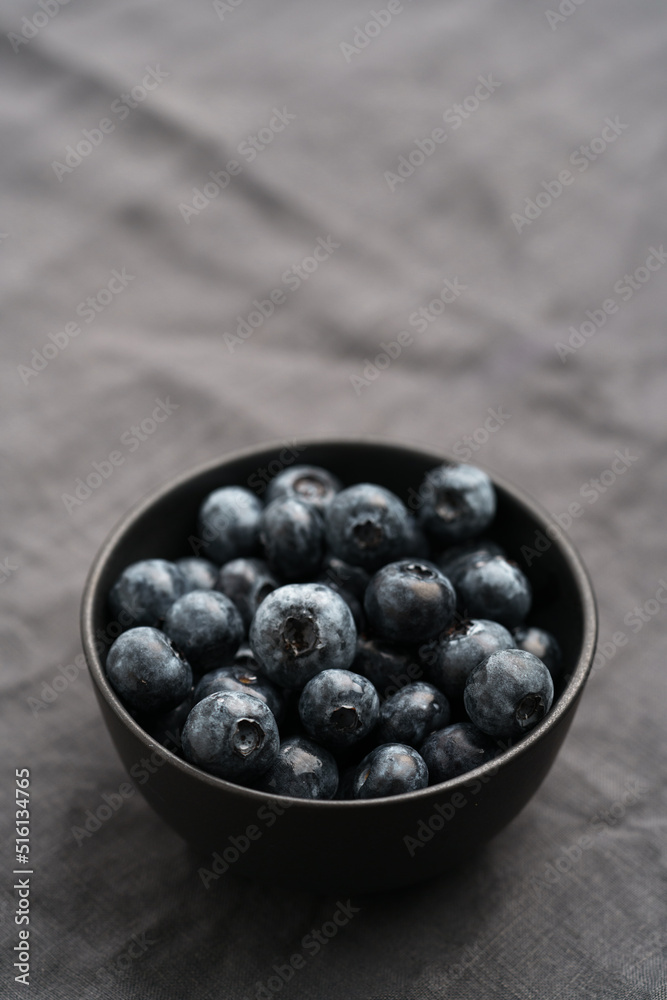 Freshly washed organic blueberries in a black bowl closeup Freshly washed organic blueberries in a black bowl closeup