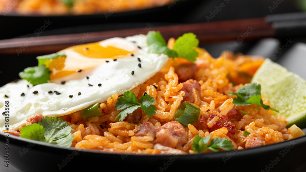 Kimchi fried rice with fried egg and bacon. Korean food Kimchi fried rice with fried egg and bacon. Korean food