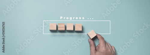 Hand putting and array wooden cube stacking for job and technology progress update concept.