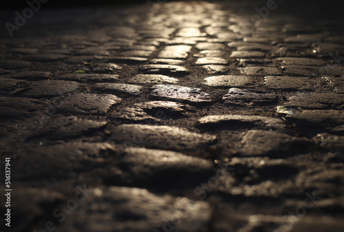 old cobblestone road in a beam of light