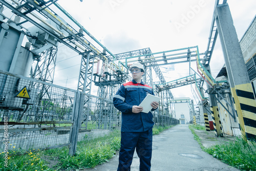 An energy engineer inspects the modern equipment of an electrical substation before commissioning. Energy and industry. Scheduled repair of electrical equipment. © Andrii