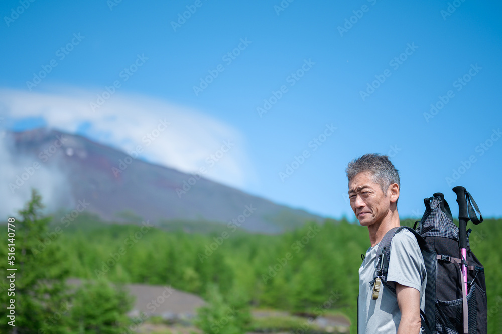 険しい顔で登山に挑戦するシニア男性
険しい顔で登山に挑戦するシニア男性