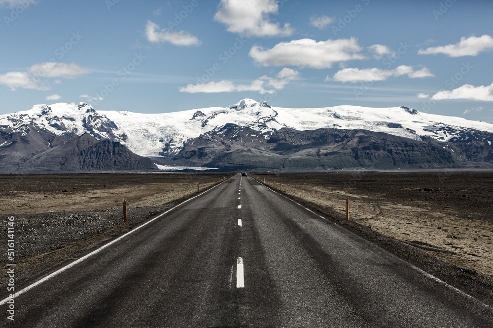 Fototapeta premium Very picturesque empty road in iceland in summer. Asphalt road as a symbol of freedom and travel.