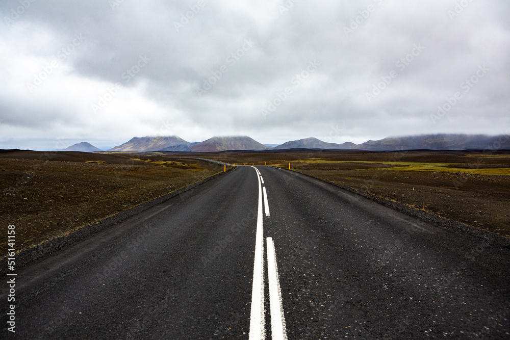 Very picturesque empty road in iceland in summer. Asphalt road as a symbol of freedom and travel.