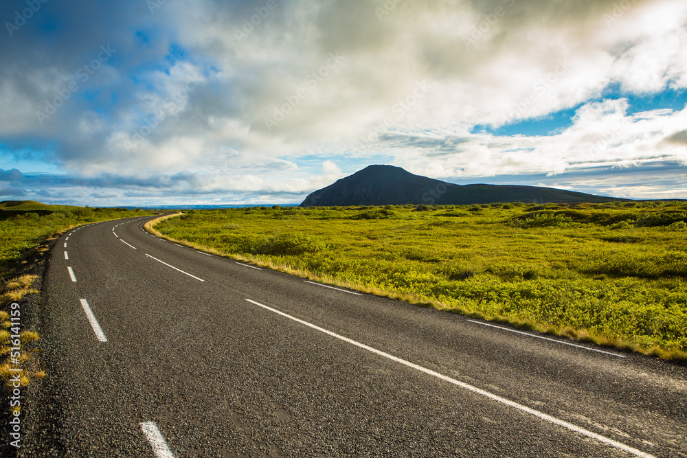 Very picturesque empty road in iceland in summer. Asphalt road as a symbol of freedom and travel.