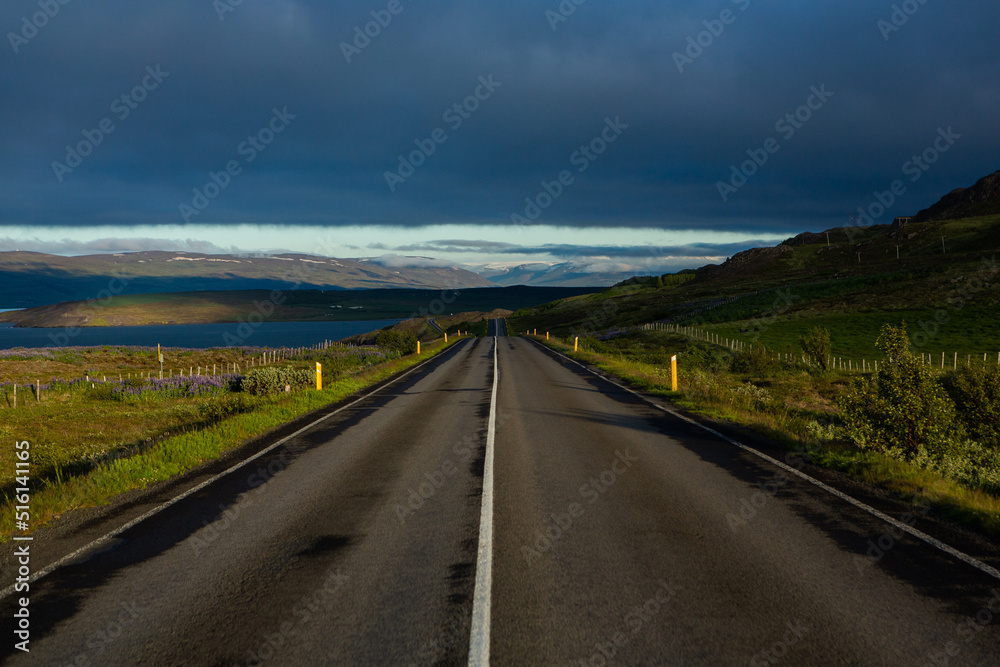 Very picturesque empty road in iceland in summer. Asphalt road as a symbol of freedom and travel.