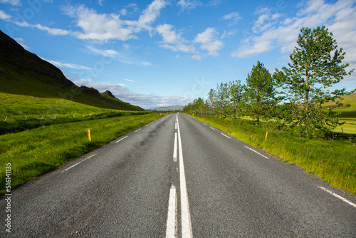 Very picturesque empty road in iceland in summer. Asphalt road as a symbol of freedom and travel.