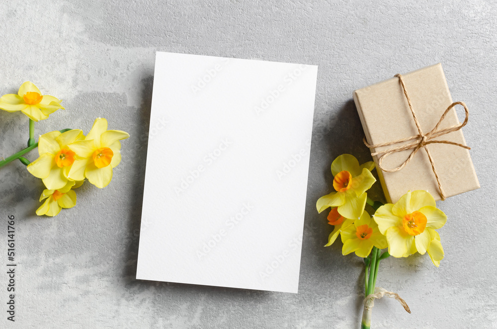 Spring greeting card mockup with gift and daffodils flowers