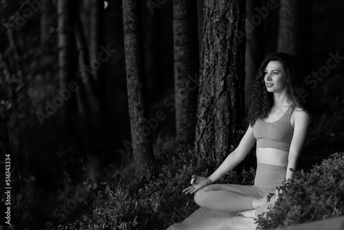 Beautiful girl meditating, yoga meditation practice in nature. © Anton