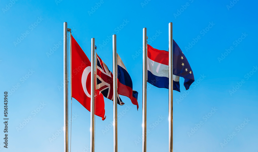 Flags of the European Union - EU, Netherlands, Turkey, Great Britain and Russia against the blue sky. empty flag. Flags of the European Union - EU, Netherlands, Turkey, Great Britain and Russia against the blue sky. empty flag.