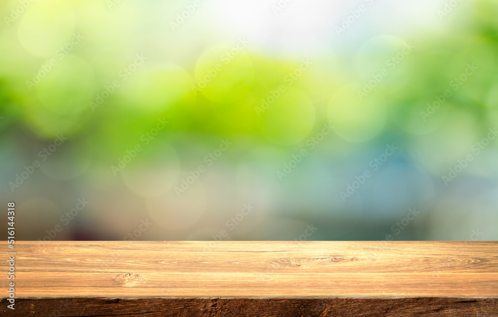 closeup top wood table with nature green blur background, for your photo montage or product display, Space for placing items on the table. closeup top wood table with nature green blur background, for your photo montage or product display, Space for placing items on the table.