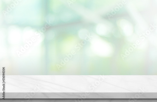 Fotografie Empty white marble over blur background, for your photo montage or product display, Space for placing items on the table, product and food display