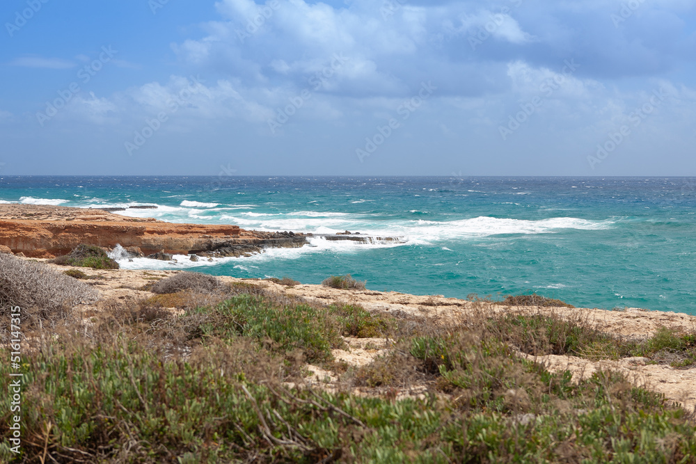 A view on stormy sea and cliffs on the shore of Cyprus