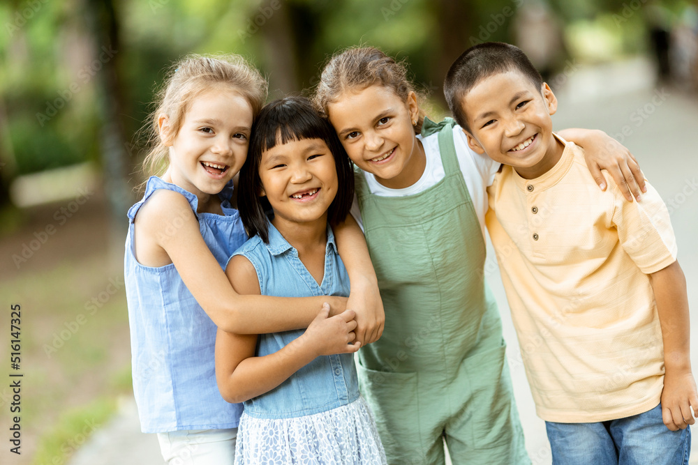 Group of asian and caucasian kids having fun in the park