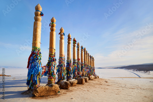 Obraz na plátně Wooden ritual pillars with multicolored ribbons on Cape Burkhan or Shamanka Rock