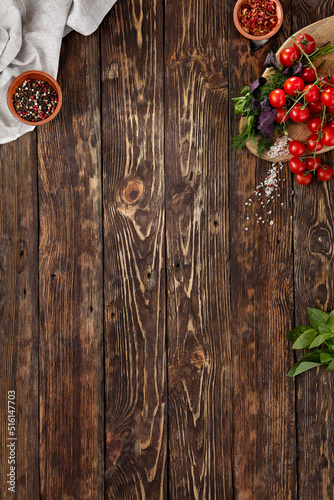 Dark wooden food background. Wooden background with ingredients in rustic style. Food background with empty place. Dark wooden table with copy space for menu. Concept food menu.
