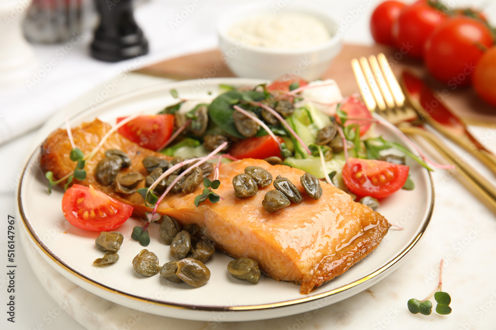 Delicious salmon with salad and capers on white table, closeup