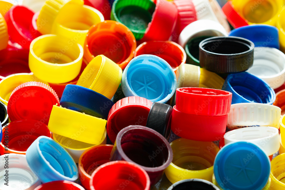 Caps from plastic bottles. Lots of colorful plastic bottle caps. Product of the chemical industry. Threat to the environment. Plastic pollution. Ecological problems. Recycle materials in production Caps from plastic bottles. Lots of colorful plastic bottle caps. Product of the chemical industry. Threat to the environment. Plastic pollution. Ecological problems. Recycle materials in production