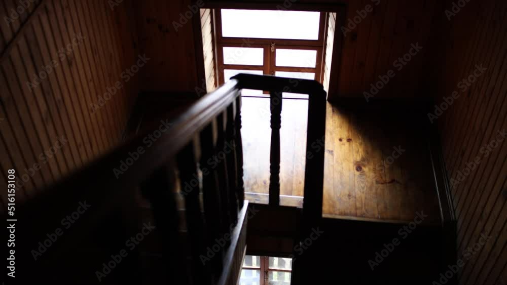 dark wooden staircase in the hotel with a window corridor dark wooden staircase in the hotel with a window corridor