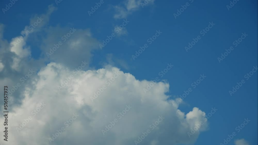Blue sky white clouds. Puffy fluffy white clouds. Summer blue sky time-lapse. Dramatic, majestic amazing blue sky. Soft white clouds form. Cloud background, 4K. Blue sky white clouds. Puffy fluffy white clouds. Summer blue sky time-lapse. Dramatic, majestic amazing blue sky. Soft white clouds form. Cloud background, 4K.