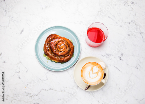 cinnamon roll breakfast with coffee latte and juice