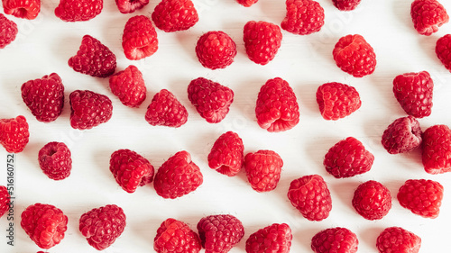 Fresh red raspberries on a white table background