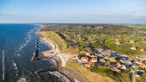 Aerial view of the scenic coast line of Denmark with the idyllic village of Lonstrup sitting on the dunes and rocks photo