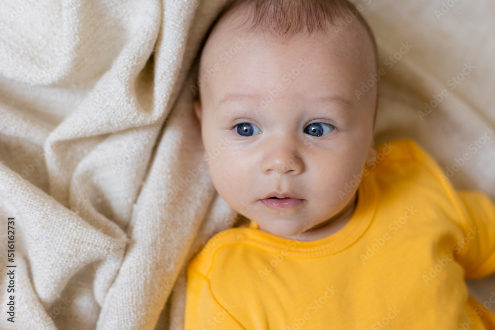 cute little boy in yellow body laying on blanket, card, banner, health, space for text cute little boy in yellow body laying on blanket, card, banner, health, space for text