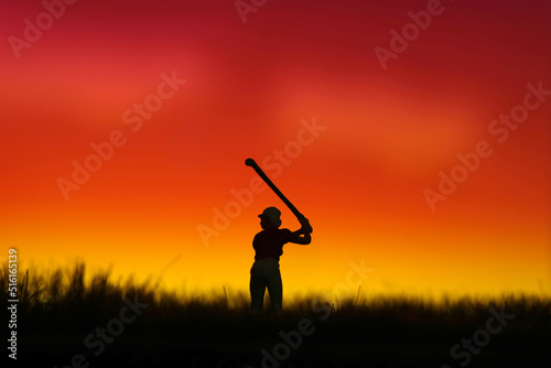 Miniature people toy figure photography. Silhouette of women golfer swing his stick at meadow field hill when sunset sunrise. © miniartkur