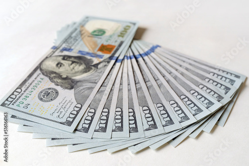 Dollar bills fanned. One hundred us dollars banknotes on white background. Concept for Business, finance, investment, saving, economics, corruption.