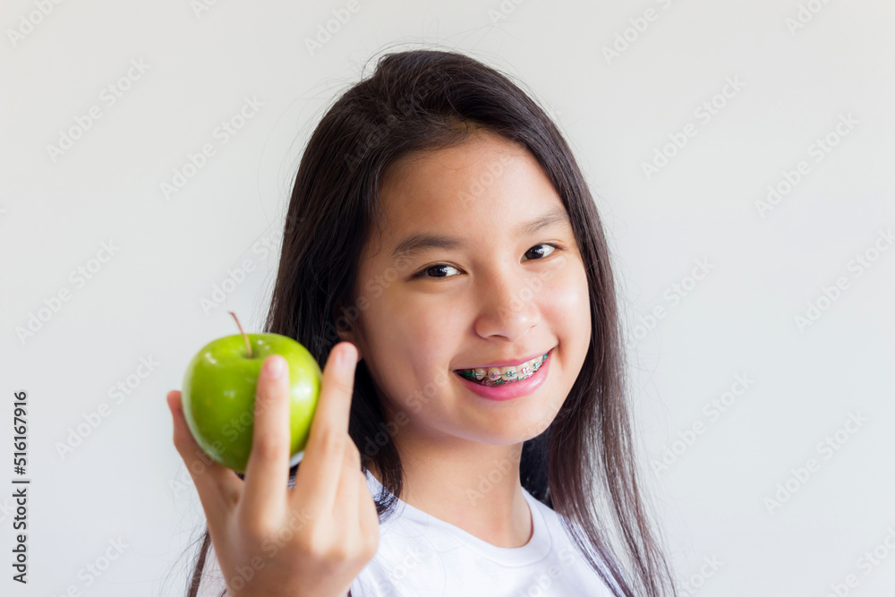 healthy asian woman show a green apple in her hand and smile happily healthy asian woman show a green apple in her hand and smile happily