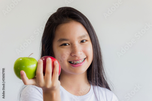 healthy asian woman hold red and green apples in her hand and smile happily